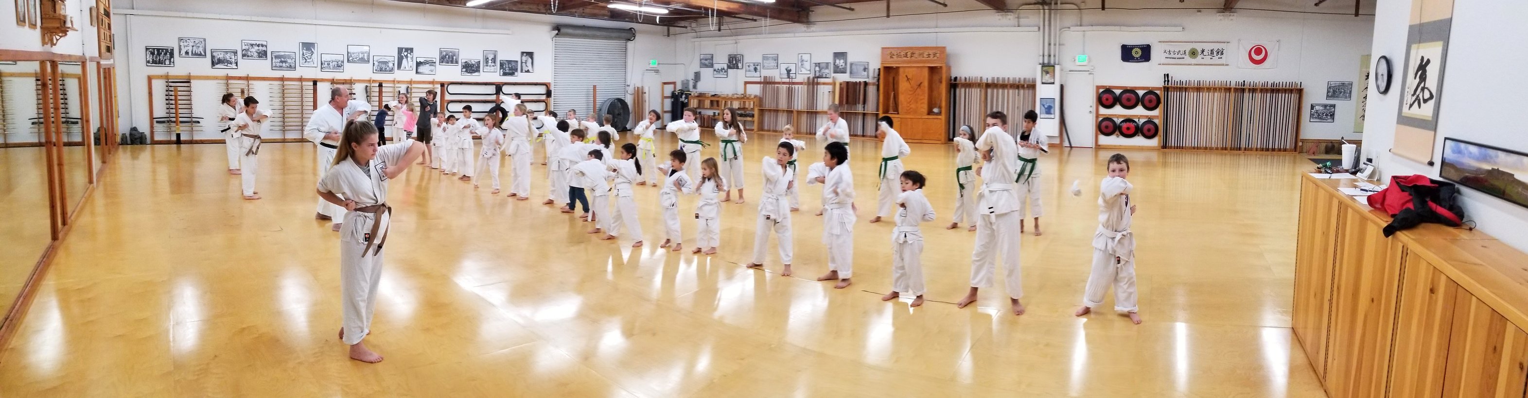 a group of kids practicing karate in a dojo