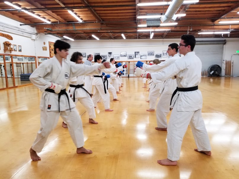 a group of people practicing karate in a dojo